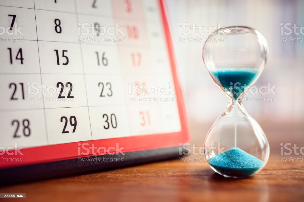 Hour glass and calendar concept for time slipping away for important appointment date, schedule and deadline